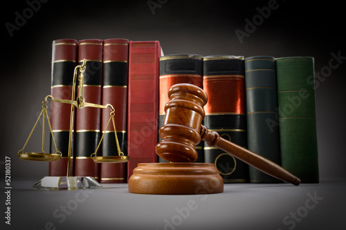 Fototapeta dla dzieci Scales of justice, law books and gavel over dark background