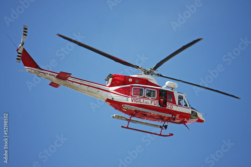 Fototapeta do kuchni patrol helicopter of firefighters in blue sky over a fire 4