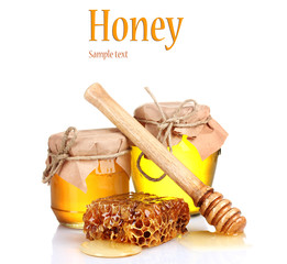 Wall Mural - Two jars of honey and honeycombs isolated on white