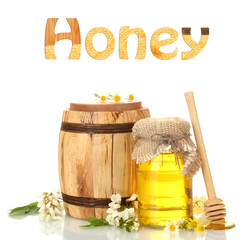 Sweet honey in jar and barrel with acacia flowers isolated