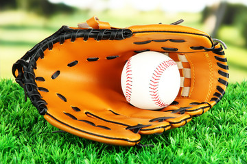 Canvas Print - Baseball glove and ball on grass in park