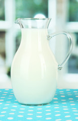 Canvas Print - Pitcher of milk on table in room