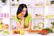 © Africa Studio - Pretty girl selects pizza or diet on kitchen background
