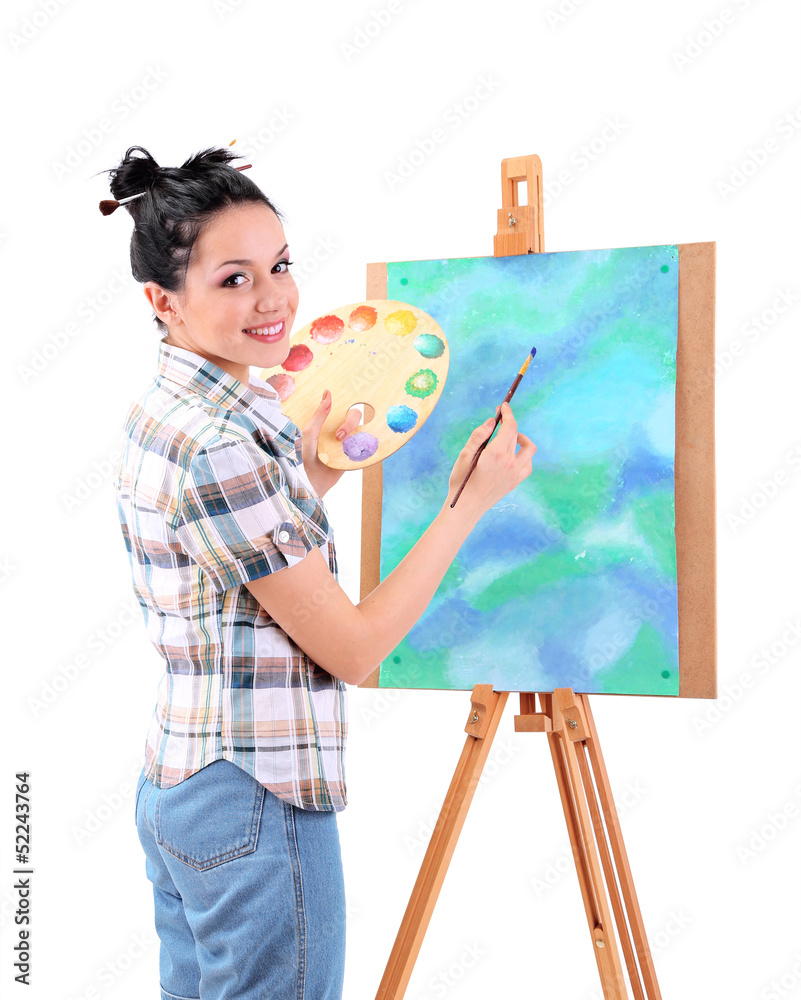 Beautiful young woman painter at work, isolated on white