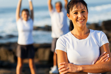 Wall Mural - fit middle aged woman with arms crossed