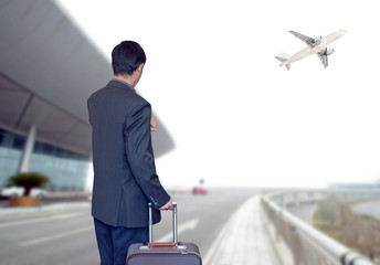 Busines person and plane on the background against  sky