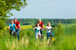 © Kzenon - Family cycling outdoors in summer