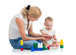 baby boy and mother playing together with construction set toy