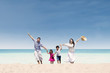 © Creativa Images - Happy family running at beach