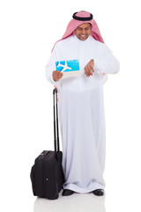 Wall Mural - middle eastern businessman checking flight time