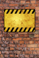 a brick wall with a warning sign