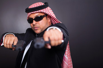 Wall Mural - middle eastern bodyguard posing with guns