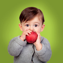 Adorable Baby Eating A Red Apple