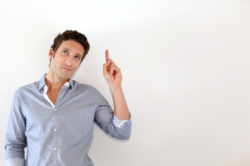 Wall Mural - Young man pointing at message on white background