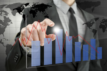 Business man pointing at interactive business graph