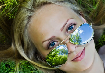 Summer reflection  in sunglasses of woman