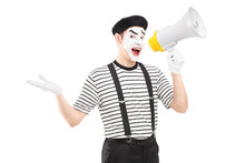 Male Mime Artist Speaking At Loudspeaker And Looking At Camera