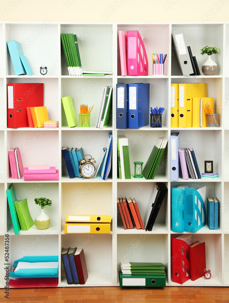 White office shelves with different stationery, close up