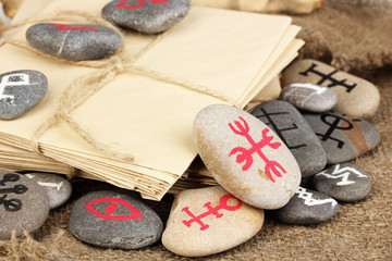 Wall Mural - Fortune telling  with symbols on stones on burlap background