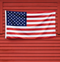 American Flag Displayed On Red Wooden Wall
