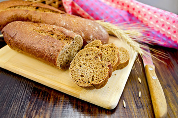 Poster - Rye baguettes with a knife and a wicker basket