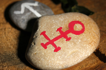 Wall Mural - Fortune telling  with symbols on stones on wooden background