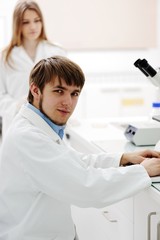 Wall Mural - Young science workers research at medical lab