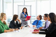 © Monkey Business - Businesswoman Conducting Meeting In Boardroom