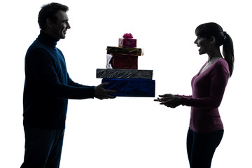 Wall Mural - couple woman man offering christmas gifts  silhouette