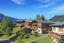 Green Alpine Meadows And Chalets.