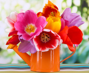 Canvas Print - Beautiful tulips in bouquet on table on bright background