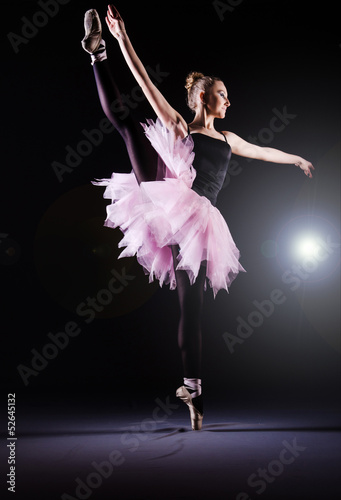 Ballerina dancing in the dark studio - 52645132
