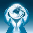 Holding a glowing earth globe in hands - Globalism