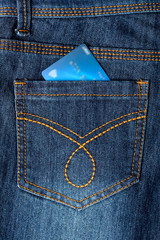 Cash card in jeans back pocket