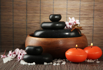 Sticker - Spa stones with flowers and candles on bamboo background