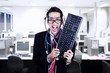 © Creativa Images - Crazy businessman hold keyboard at office