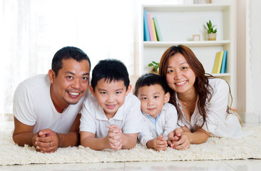 beautiful asian family lying on the floor