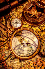 vintage magnifying glass lies on an ancient world map