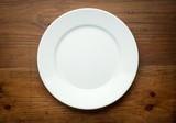 Fototapeta  - Empty white plate on wooden table