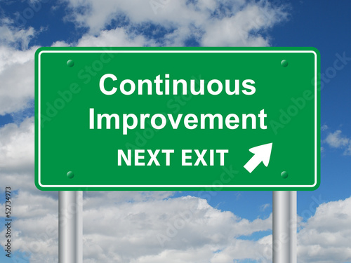 Fotografía CONTINUOUS IMPROVEMENT NEXT EXIT Sign (efficiency quality lean)