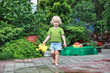 © endostock - little barefoot girl  with watering can - portrait