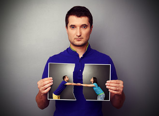 Wall Mural - man holding the photo of young couple