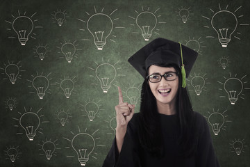 Wall Mural - Happy student graduate in front of light bulbs drawing