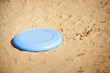 Frisbee lying in sand