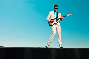 Wall Mural - Vintage fifties male guitar player with white suit and sunglasse