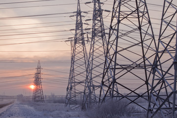 An unusual view of the high voltage on a snowy meadow