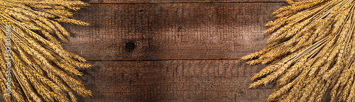 Naklejka dekoracyjna wheat on the wood background. banner