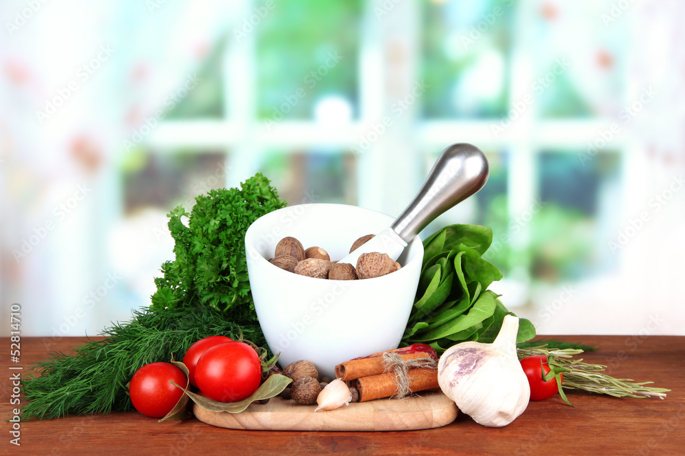 Composition of mortar, spices, tomatoes and  green herbs,