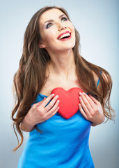 Heart, love symbol young happy woman hold. Isolated on studio b