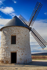 old Windmill XVI century white stone and wood